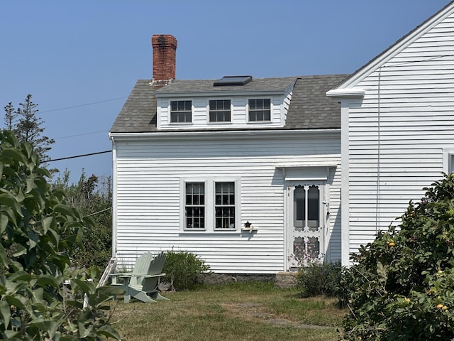 back of house with a yard