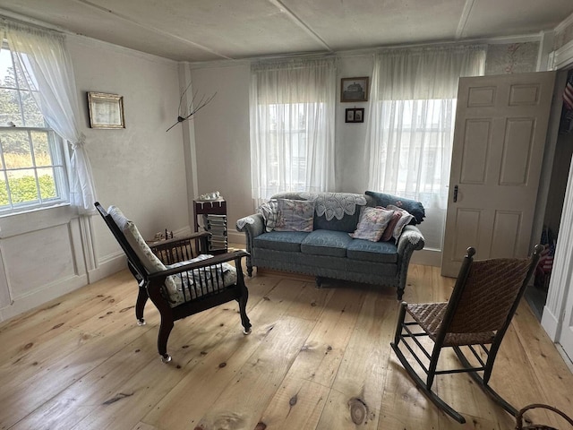 sitting room featuring crown molding and light wood-type flooring