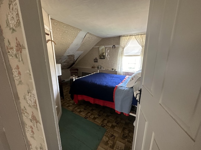 bedroom featuring lofted ceiling, parquet floors, and a textured ceiling