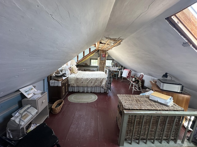 bedroom with vaulted ceiling and dark hardwood / wood-style floors