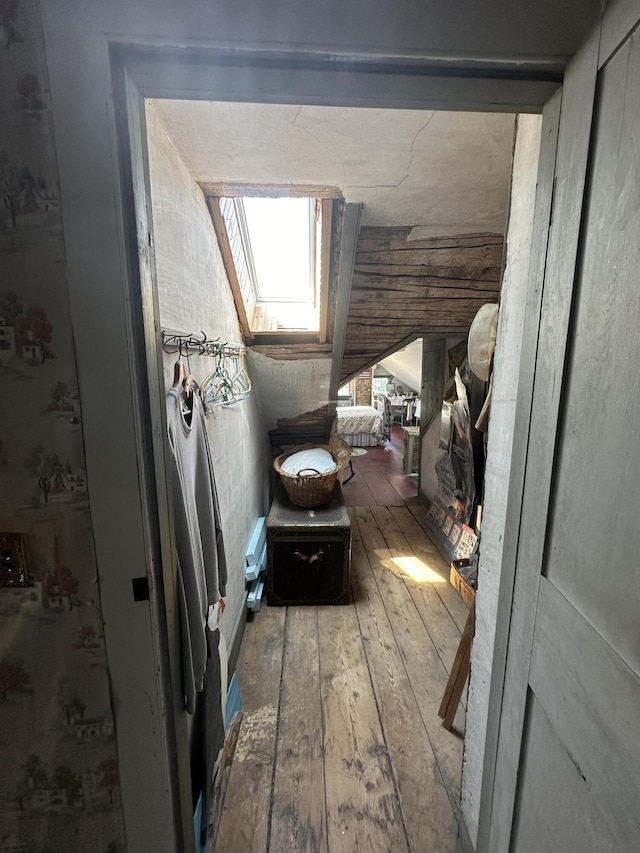 interior space with hardwood / wood-style floors and a skylight