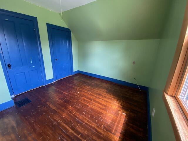 interior space featuring lofted ceiling and wood-type flooring