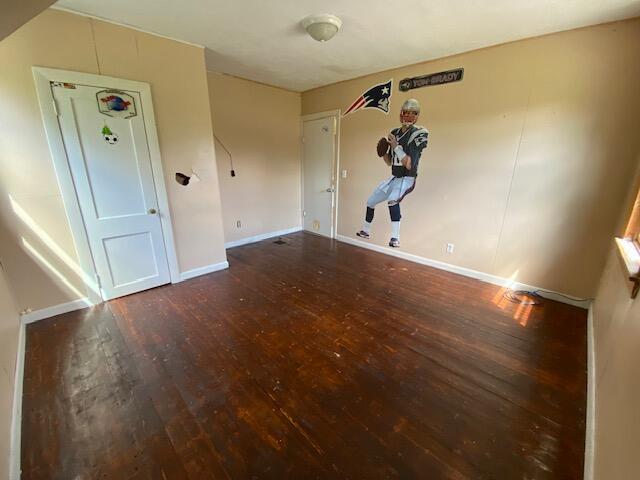 spare room with hardwood / wood-style floors