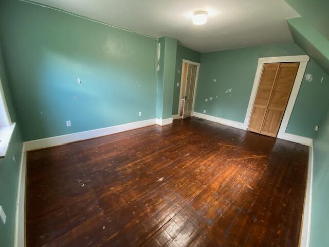 unfurnished bedroom featuring hardwood / wood-style flooring and a closet