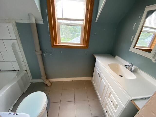 bathroom with vanity, tile patterned flooring, and toilet