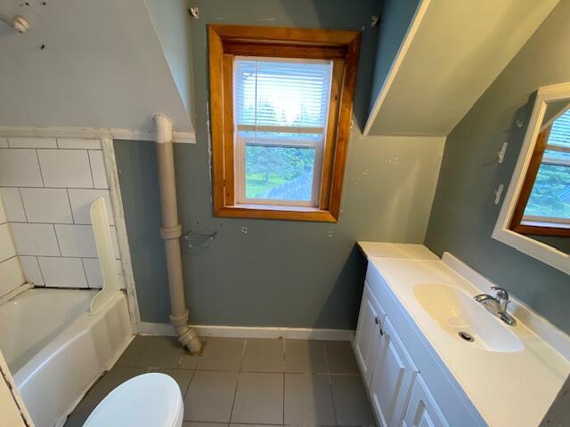 full bathroom featuring vanity, tile patterned flooring,  shower combination, and toilet