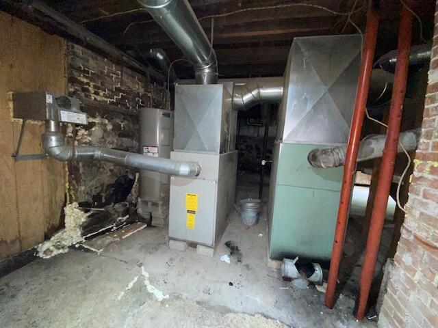 utility room with water heater and heating unit