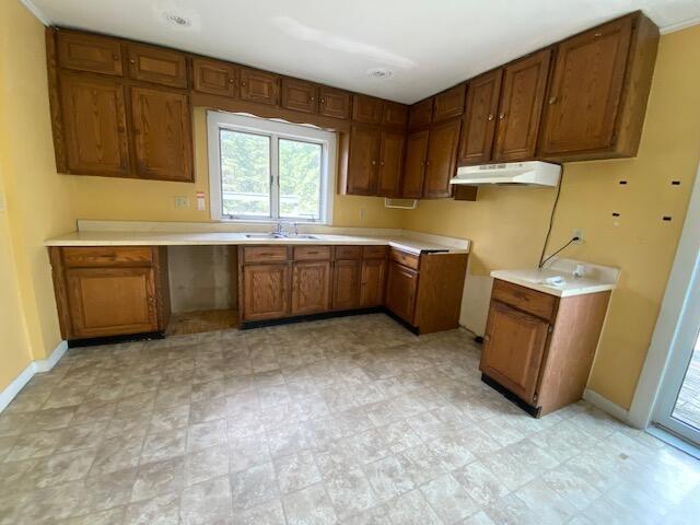 kitchen featuring light tile patterned flooring and sink