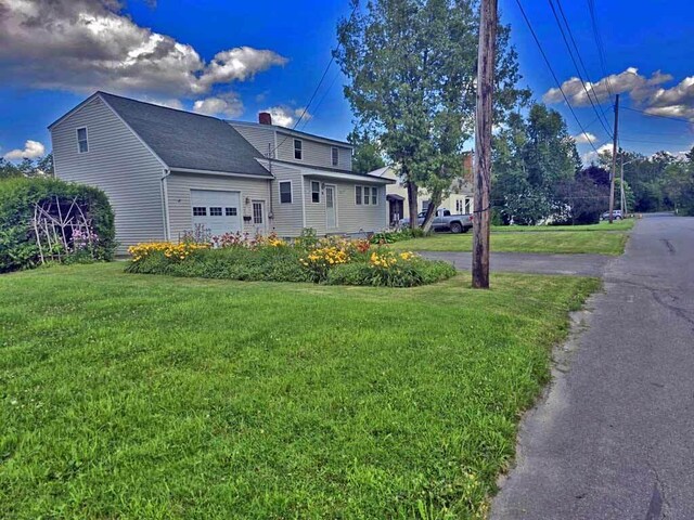 view of front of property featuring a garage and a front yard