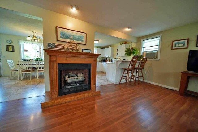 living room with a notable chandelier and light hardwood / wood-style flooring