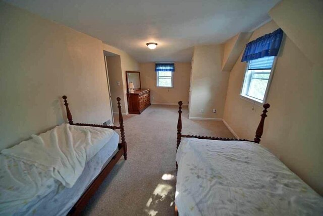 carpeted bedroom featuring multiple windows