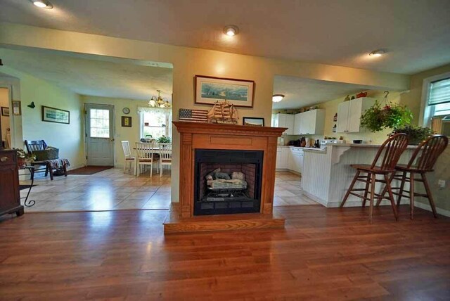 living room with a chandelier and light wood-type flooring