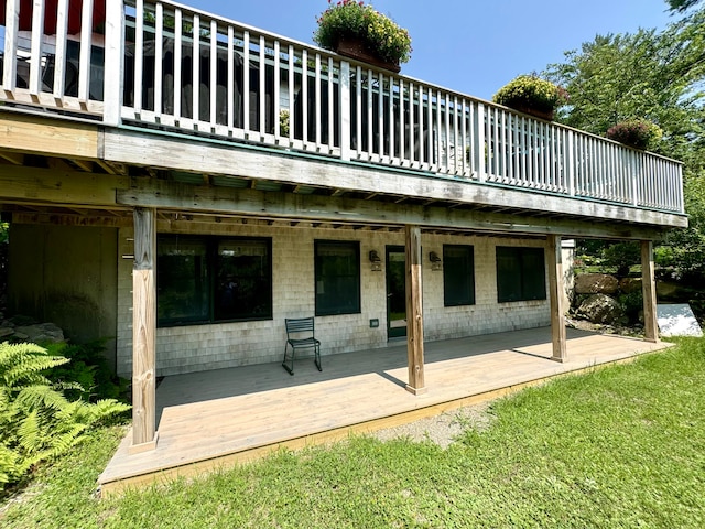 back of house featuring a yard and a wooden deck