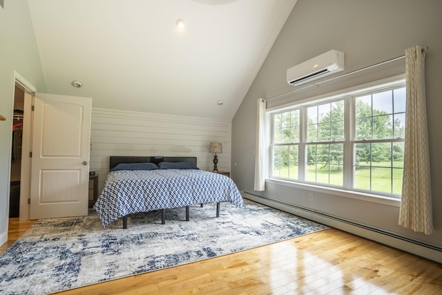 bedroom with lofted ceiling, a wall mounted air conditioner, wood-type flooring, and baseboard heating