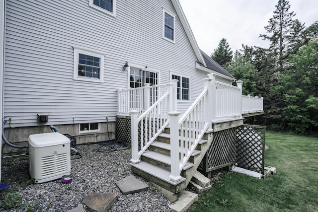 rear view of house featuring a deck and a yard