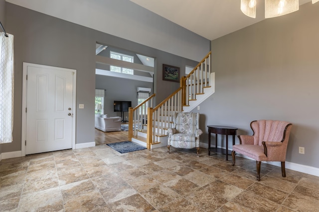 foyer entrance featuring high vaulted ceiling