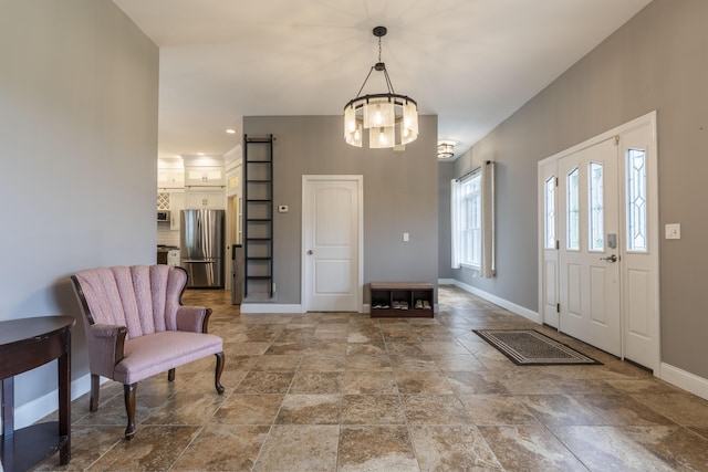 foyer entrance with a notable chandelier