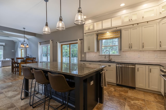 kitchen with sink, backsplash, pendant lighting, a kitchen island, and stainless steel dishwasher