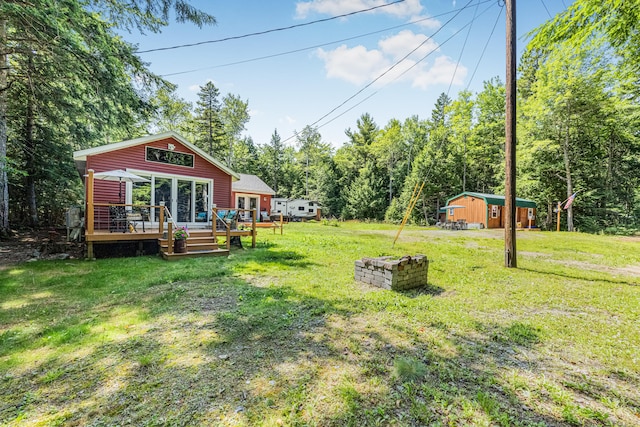 view of yard with an outdoor structure and a deck