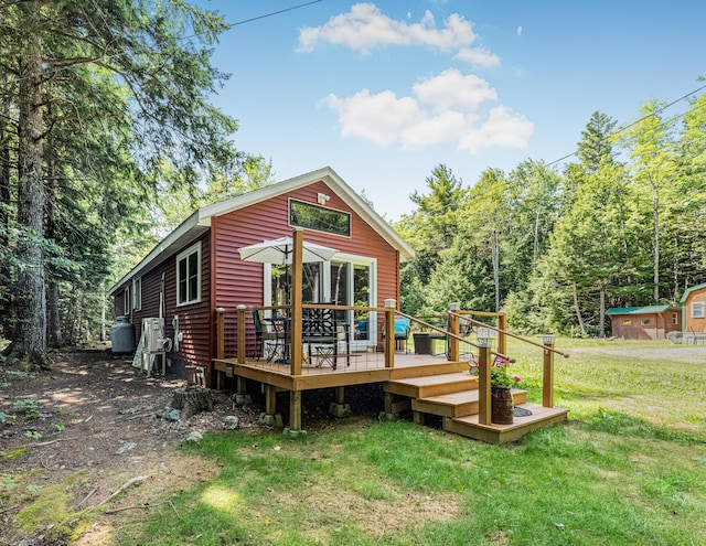 back of house featuring a deck and a yard