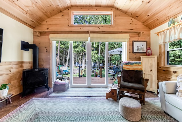 interior space featuring wooden ceiling, wood-type flooring, vaulted ceiling, and a wood stove