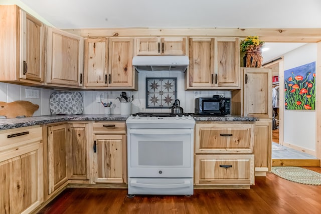 kitchen with dark stone counters, light brown cabinetry, decorative backsplash, dark hardwood / wood-style floors, and white range oven