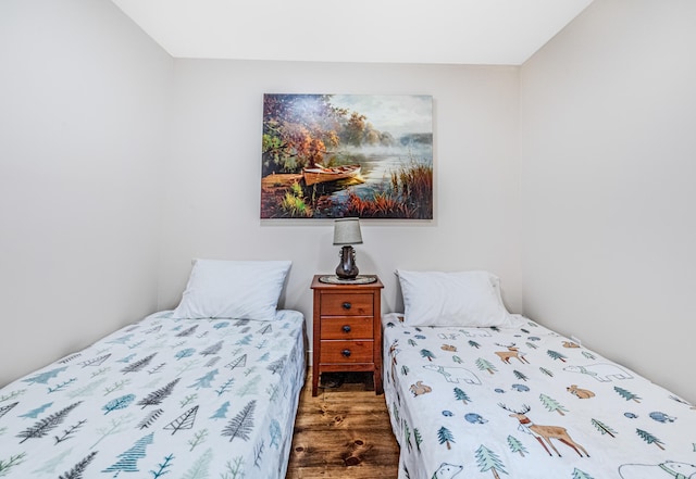 bedroom with dark wood-type flooring