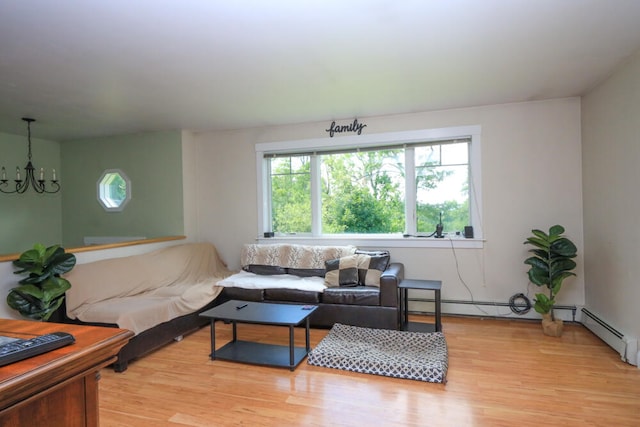 living room featuring a chandelier and light wood-type flooring