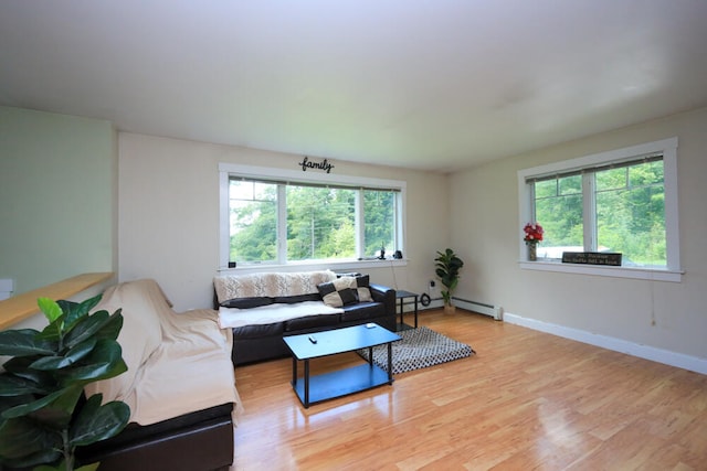 living room with a baseboard radiator and light hardwood / wood-style flooring