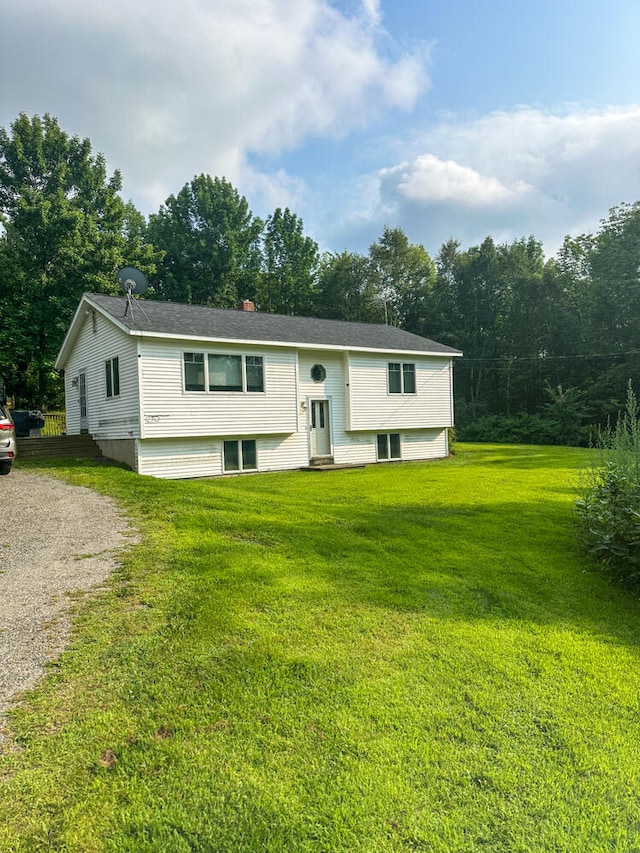 bi-level home with a front lawn