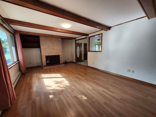 unfurnished living room with a baseboard heating unit, brick wall, beamed ceiling, hardwood / wood-style flooring, and a brick fireplace