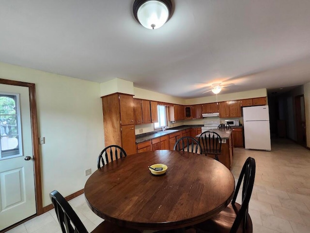 dining room featuring light tile patterned flooring and sink