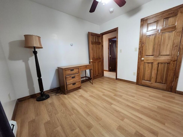 unfurnished office with ceiling fan, light hardwood / wood-style floors, and a baseboard radiator