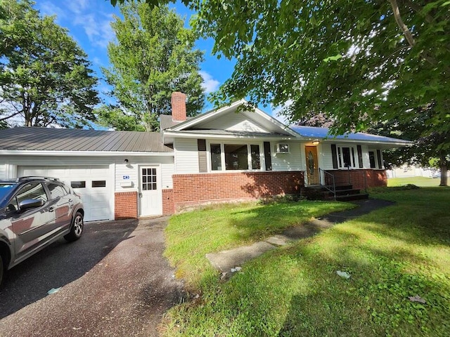 view of front of property with a front yard and a garage