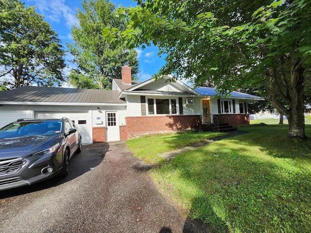 view of front of property featuring a garage and a front lawn