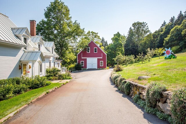 exterior space with an outbuilding and a front lawn