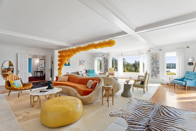 living room featuring beam ceiling, crown molding, and light hardwood / wood-style flooring