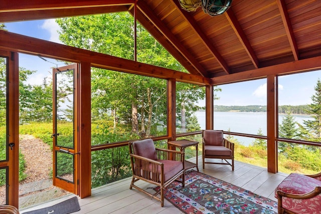 sunroom with vaulted ceiling with beams, wood ceiling, and a water view