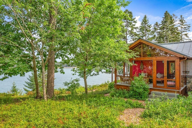 exterior space featuring a water view and french doors