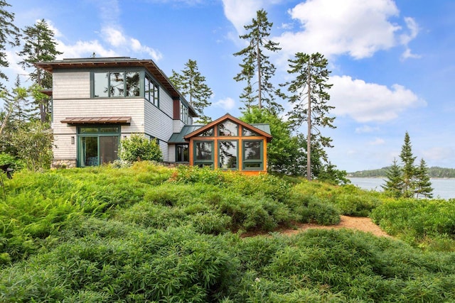 back of house with a water view