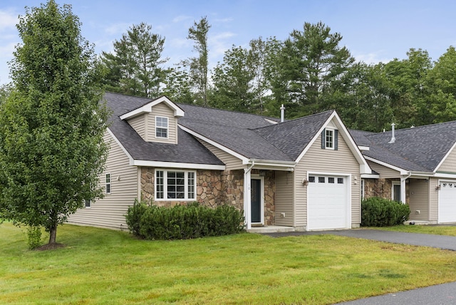 view of front of property featuring a garage and a front lawn