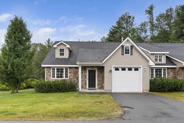 view of front of property featuring a garage and a front lawn