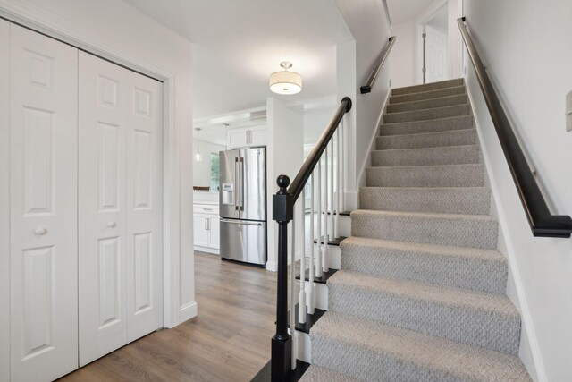 stairs featuring light hardwood / wood-style flooring