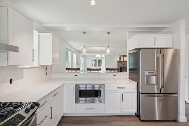 kitchen with white cabinetry, tasteful backsplash, dark hardwood / wood-style floors, and stainless steel appliances