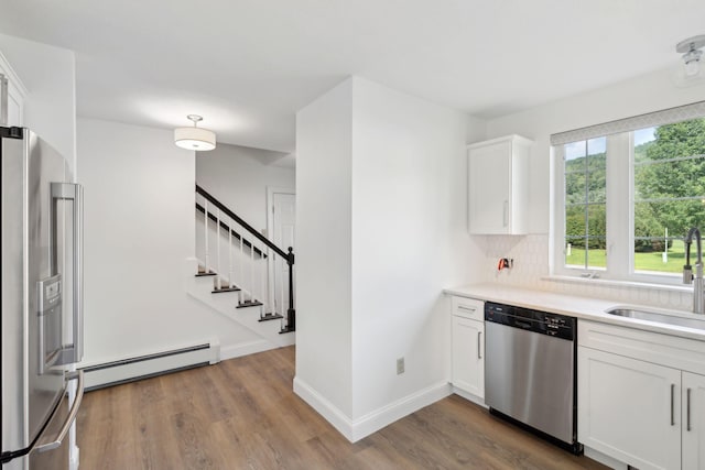 kitchen with white cabinetry, wood-type flooring, appliances with stainless steel finishes, and sink