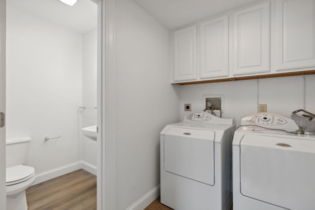 laundry area featuring separate washer and dryer and light wood-type flooring