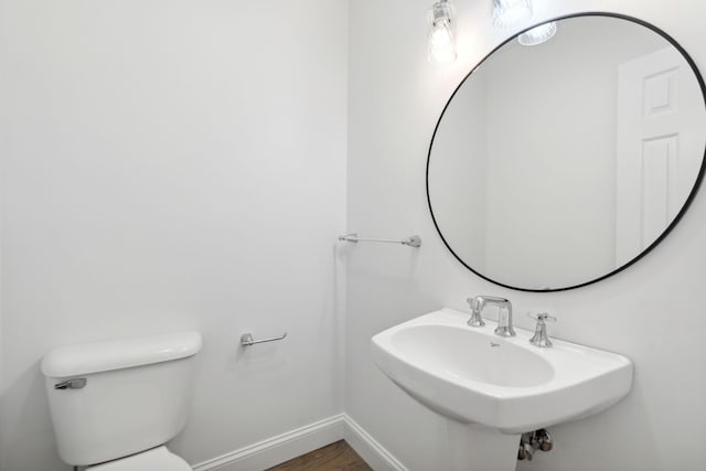 bathroom featuring sink, toilet, and hardwood / wood-style flooring