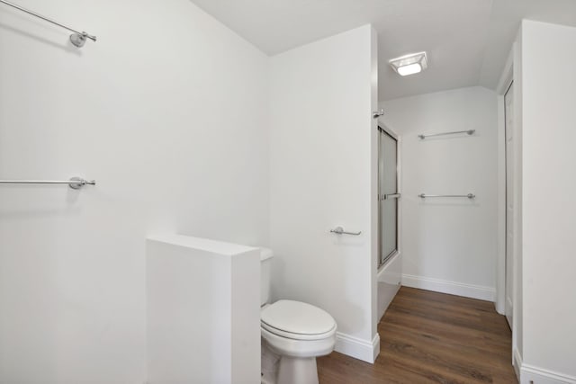 bathroom with shower / bath combination with glass door, toilet, and hardwood / wood-style flooring