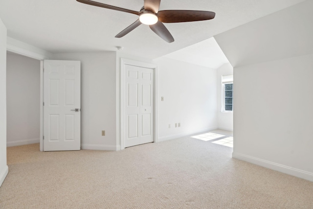 additional living space featuring light carpet, ceiling fan, and vaulted ceiling