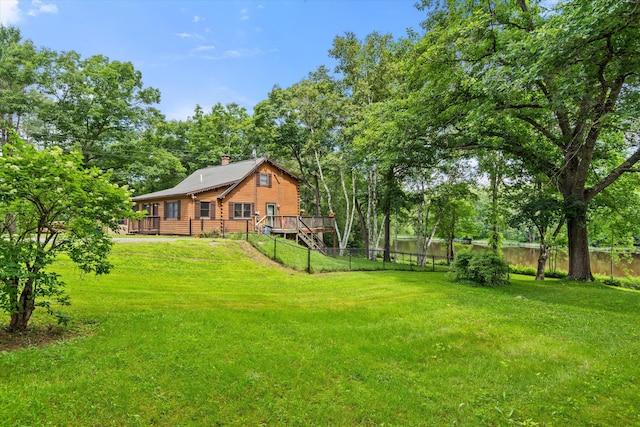 view of yard with a deck with water view